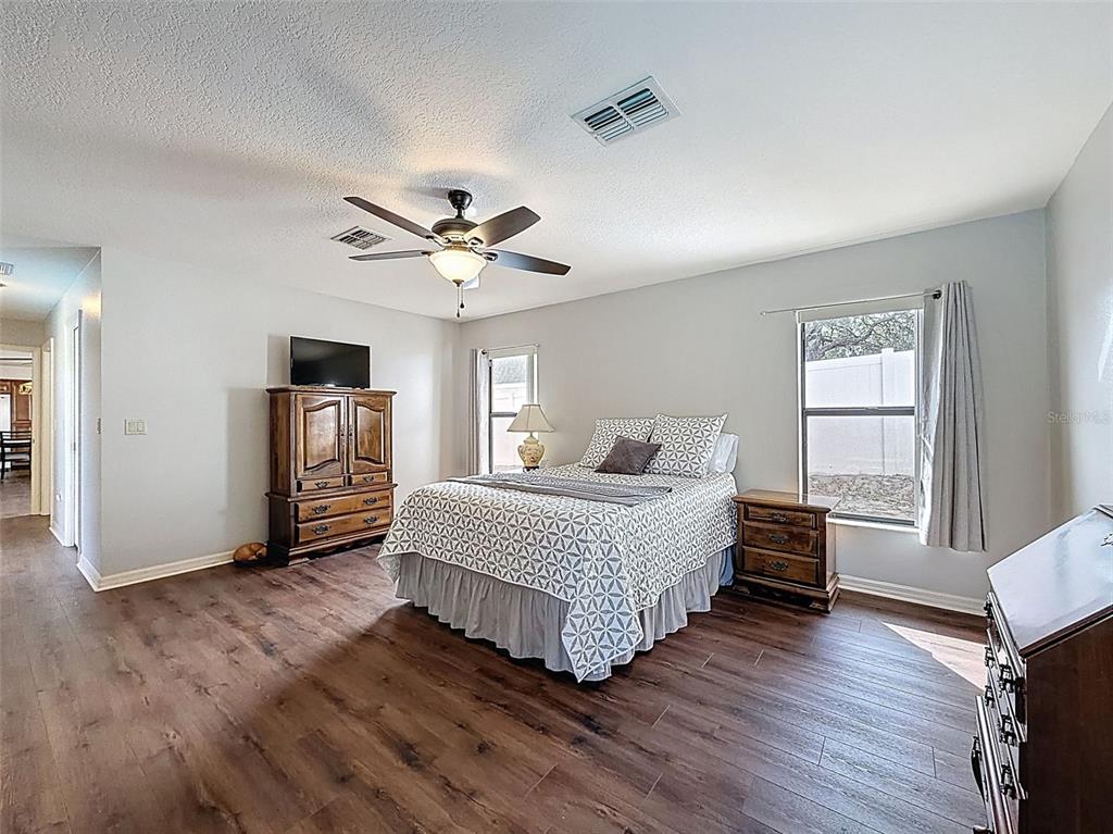 4289 Castle Avenue Spring Hill, FL 34609 - Photo 49 of 50 a spacious bedroom with a bed closet and a window