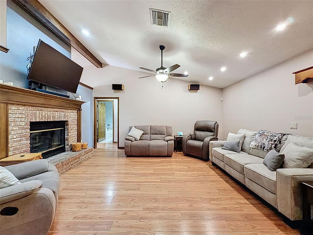 4289 Castle Avenue Spring Hill, FL 34609 - Photo 8 of 50 a living room with furniture and a fireplace