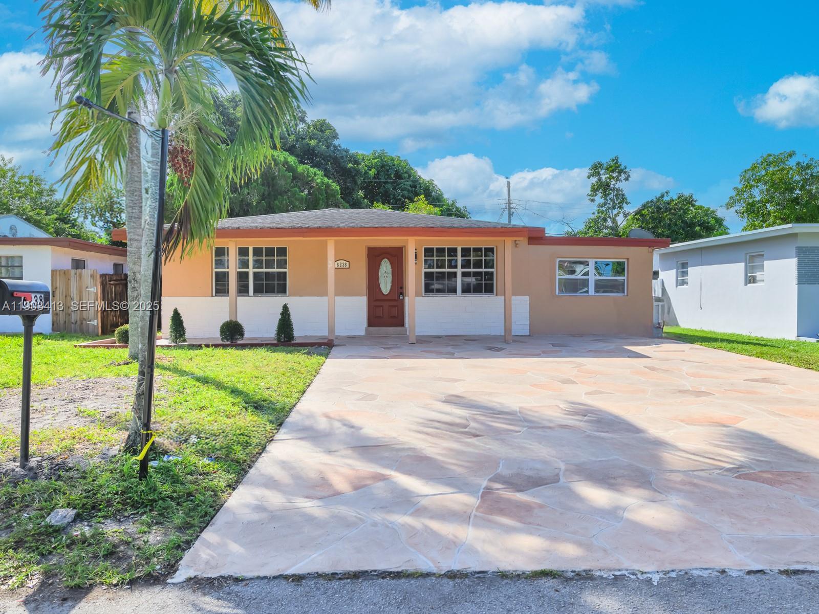 a front view of house with yard and green space