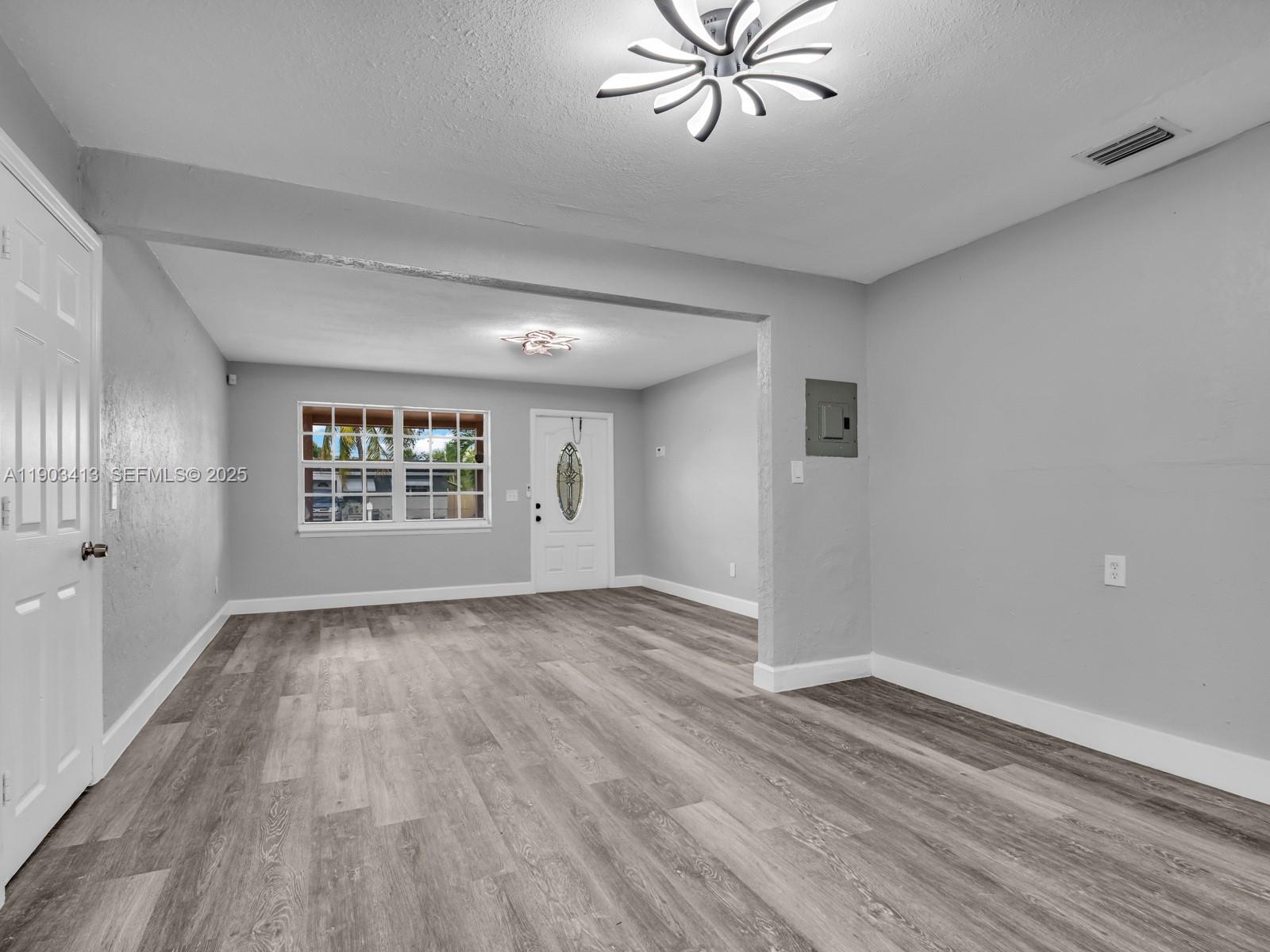 6238 Southwest 24th Street Miramar, FL 33023 - Photo 12 of 33 wooden floor in an empty room with a window