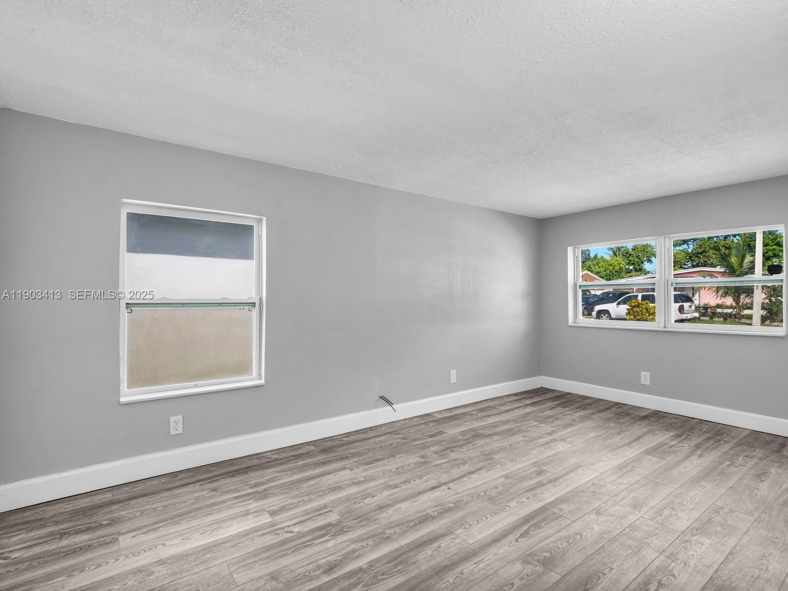 6238 Southwest 24th Street Miramar, FL 33023 - Photo 13 of 33 a view of an empty room with window and hardwood floor