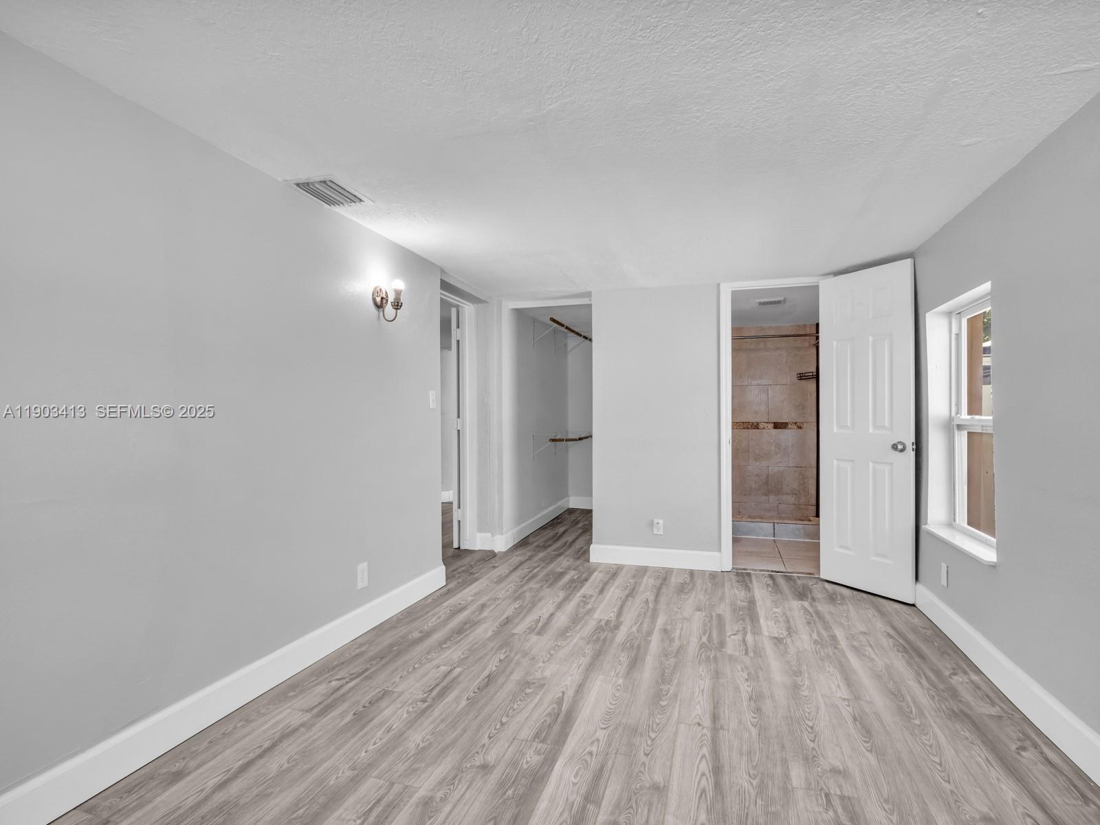 6238 Southwest 24th Street Miramar, FL 33023 - Photo 14 of 33 a view of hallway with an empty room and wooden floor