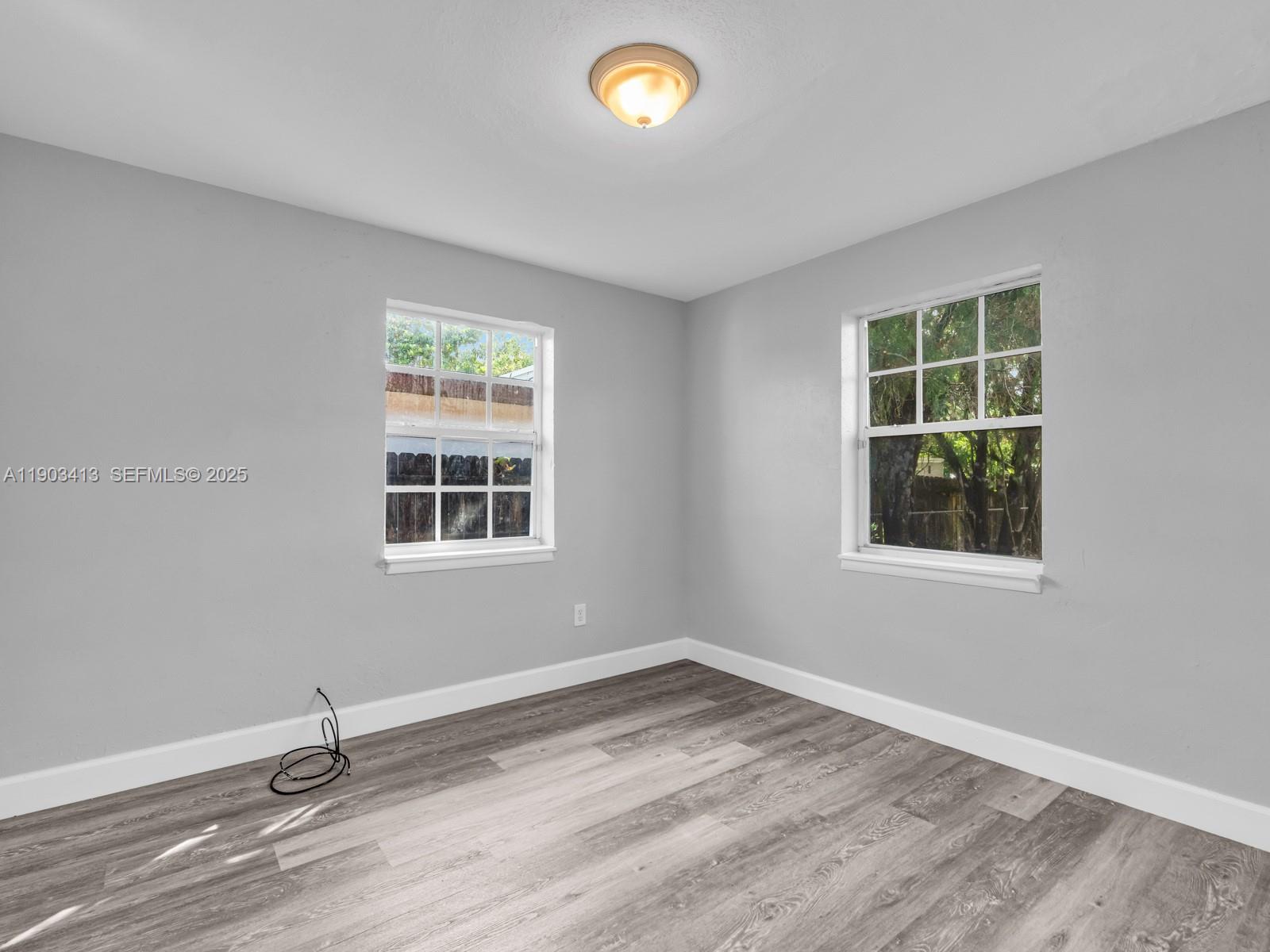 6238 Southwest 24th Street Miramar, FL 33023 - Photo 16 of 33 a view of an empty room with wooden floor and a window