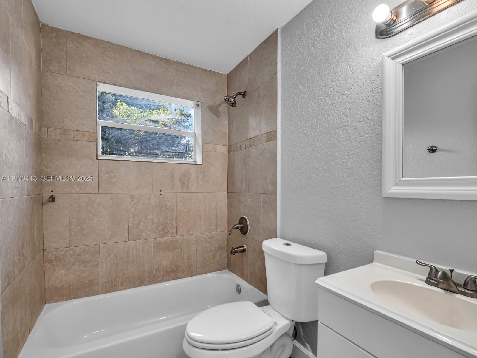 6238 Southwest 24th Street Miramar, FL 33023 - Photo 18 of 33 a bathroom with a toilet a sink and bathtub