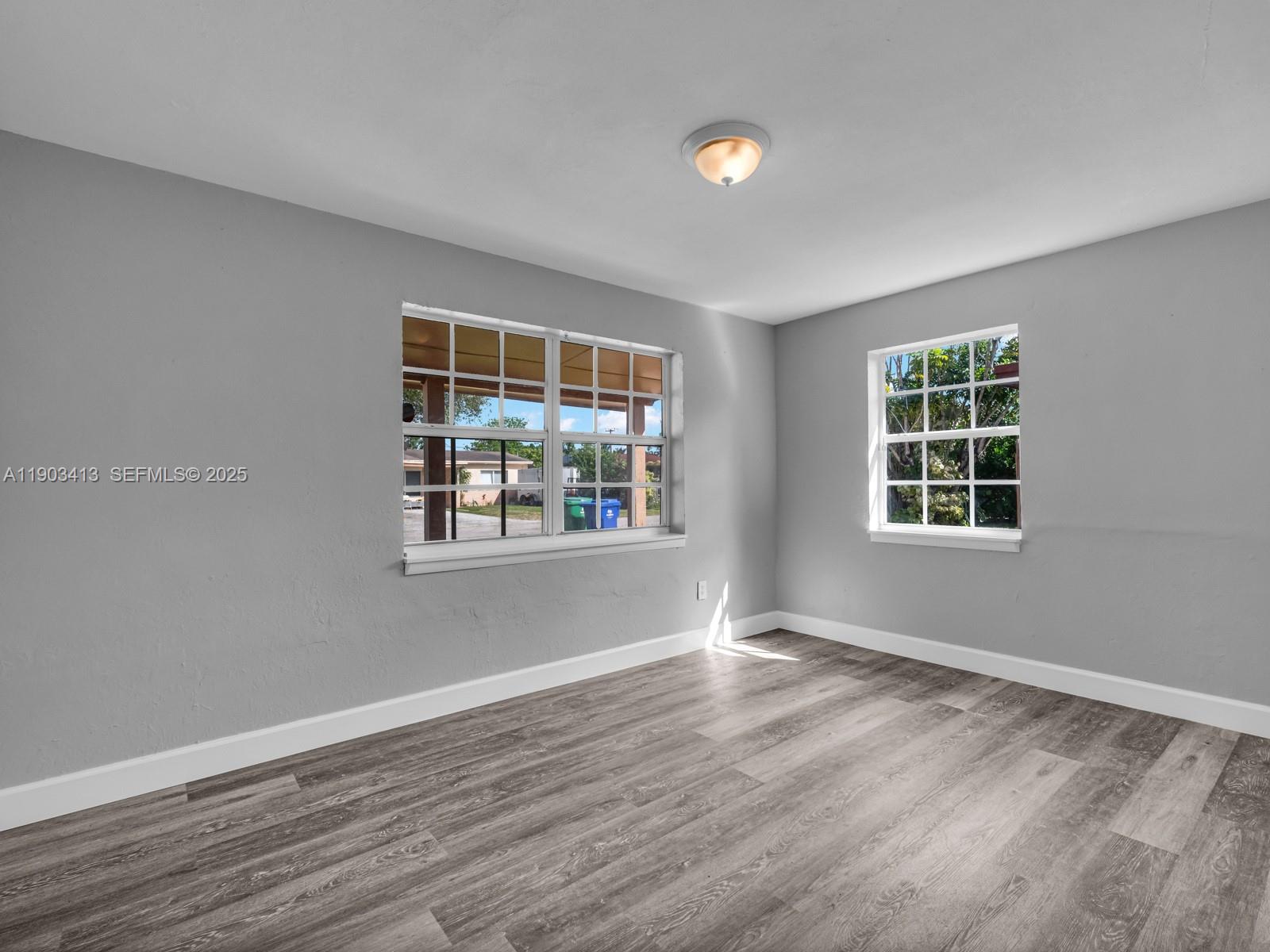 6238 Southwest 24th Street Miramar, FL 33023 - Photo 19 of 33 a view of an empty room with wooden floor and a window