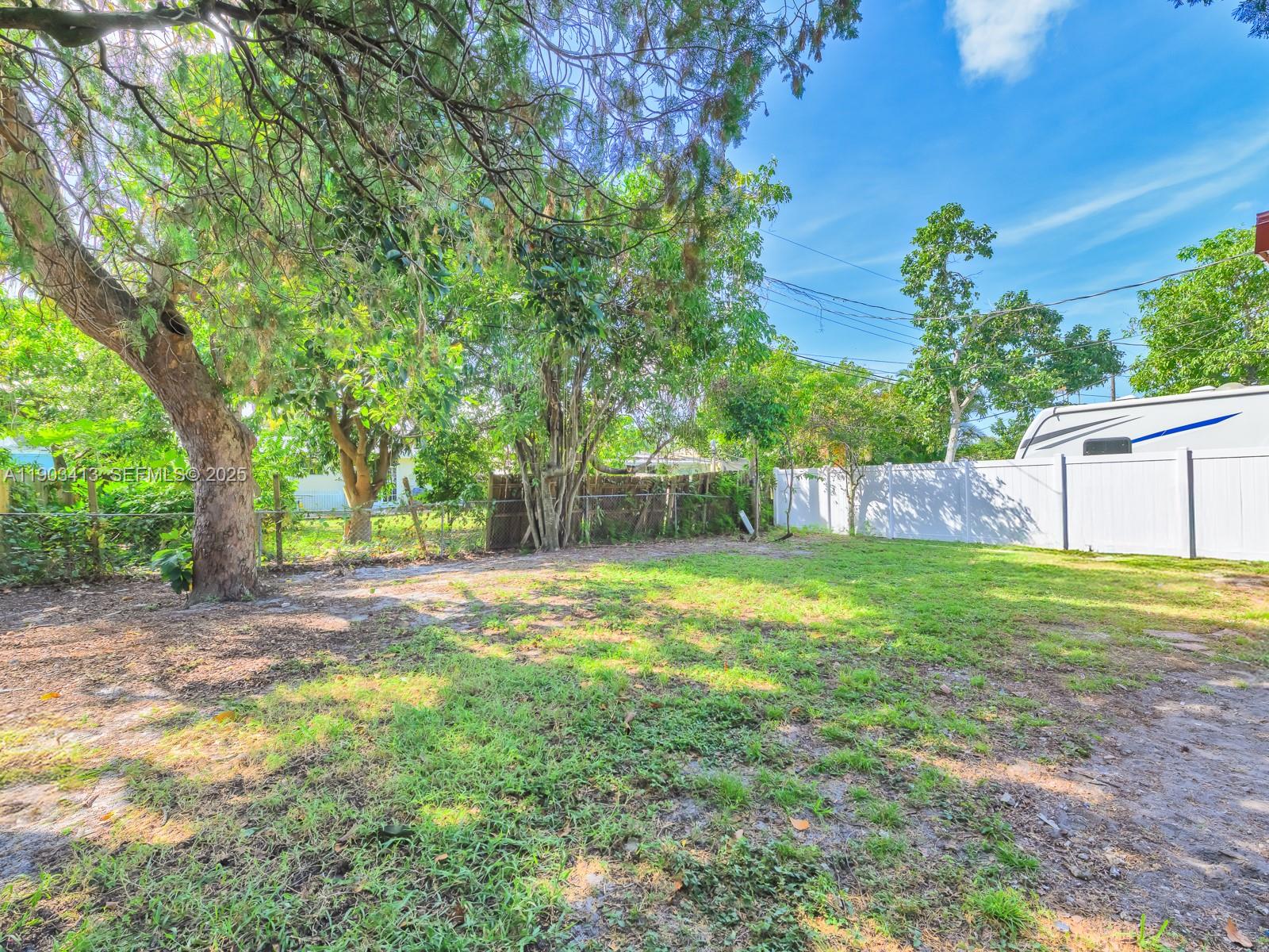 6238 Southwest 24th Street Miramar, FL 33023 - Photo 27 of 33 a view of a yard with a house and a tree