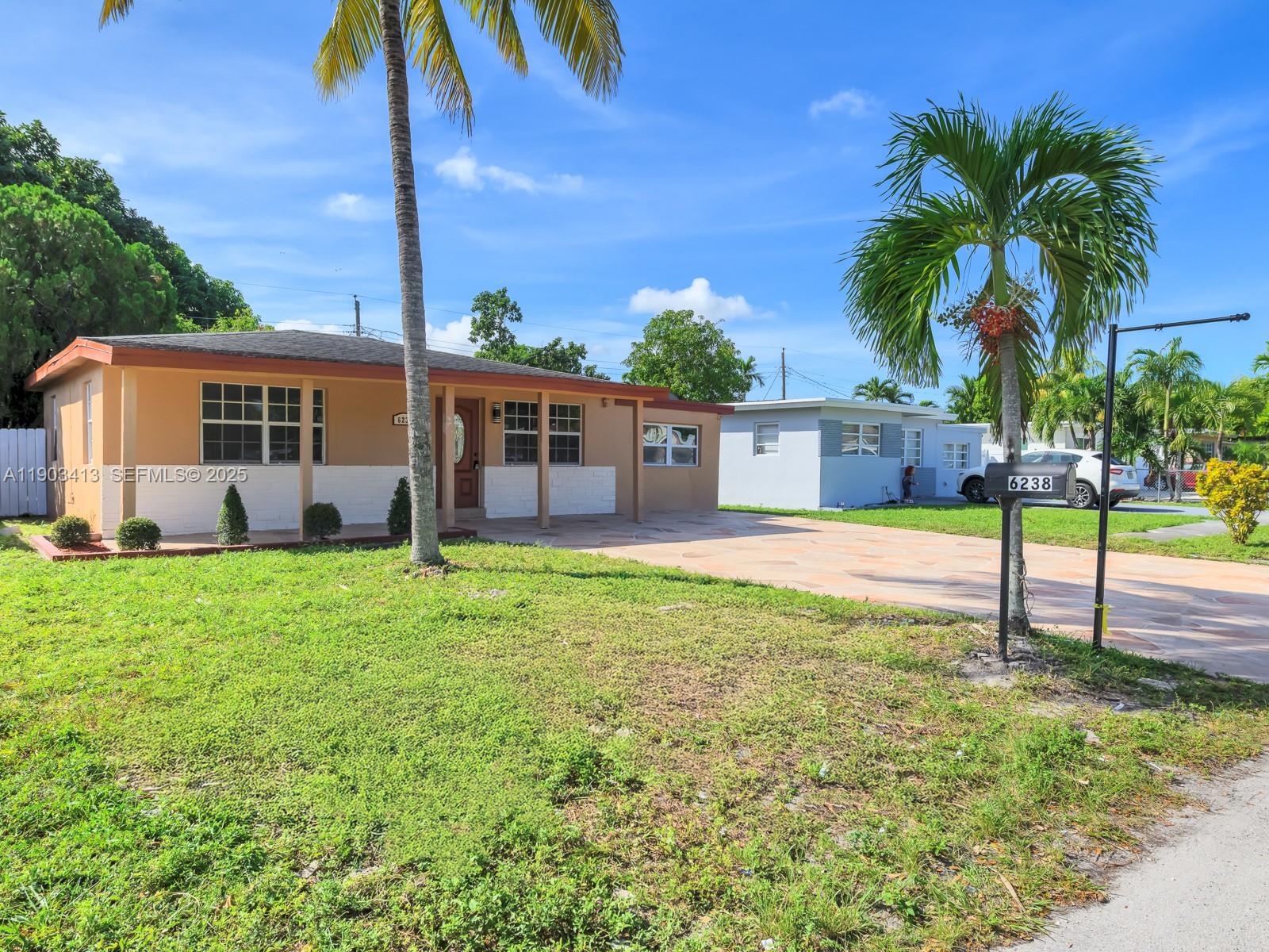 6238 Southwest 24th Street Miramar, FL 33023 - Photo 3 of 33 a view of a house with a backyard and a tree
