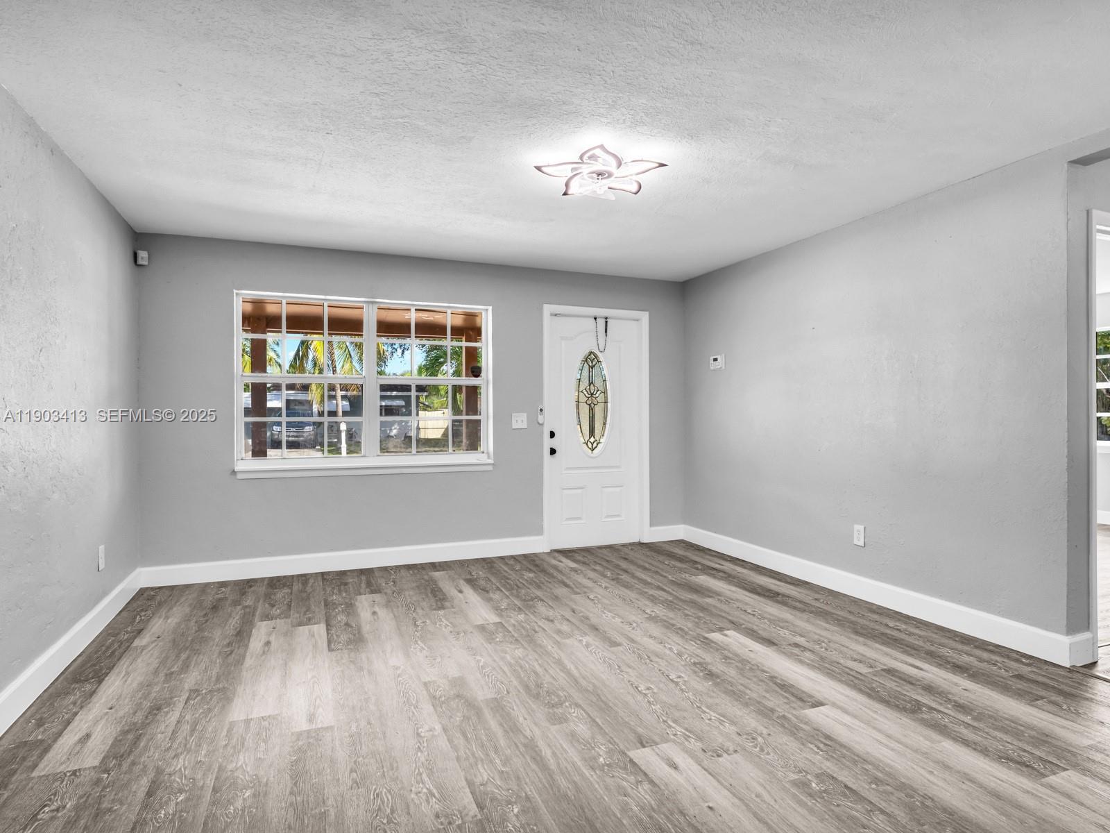 6238 Southwest 24th Street Miramar, FL 33023 - Photo 4 of 33 wooden floor in an empty room with a window