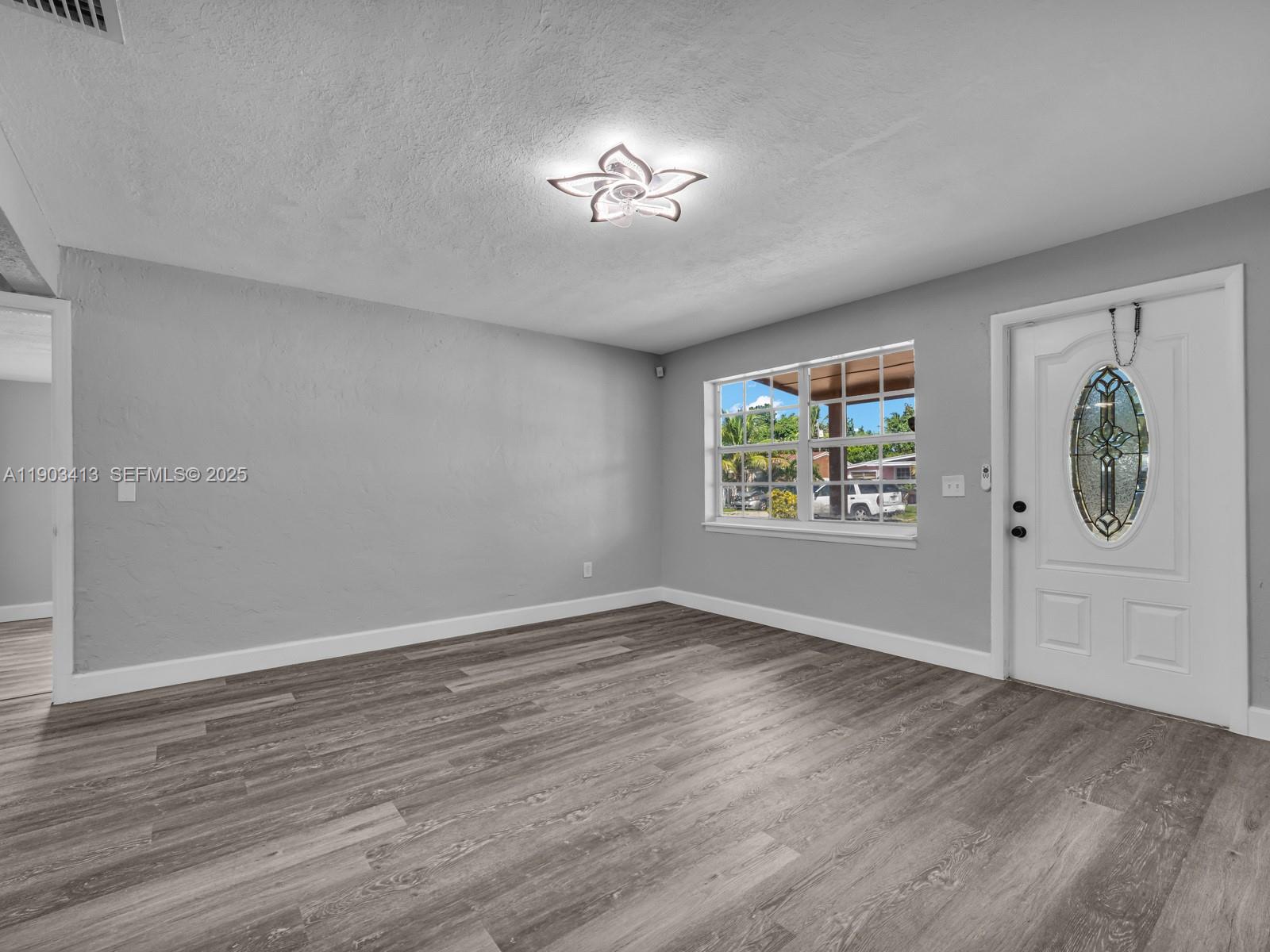 6238 Southwest 24th Street Miramar, FL 33023 - Photo 6 of 33 wooden floor in an empty room with a window
