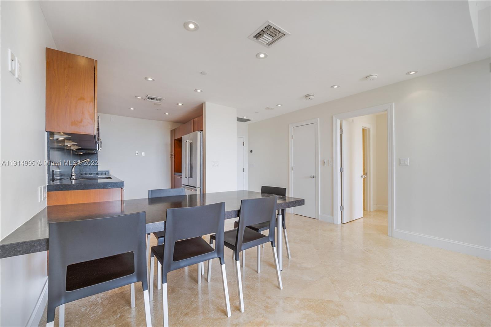 151 Crandon Boulevard, Unit 439 Key Biscayne, FL 33149 - Photo 5 of 24 a view of a dining room with furniture