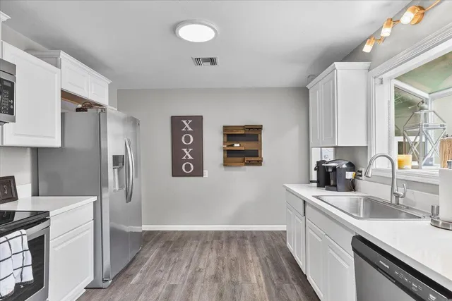a kitchen with a sink stove and refrigerator
