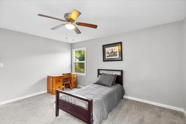 a bedroom with a bed and window