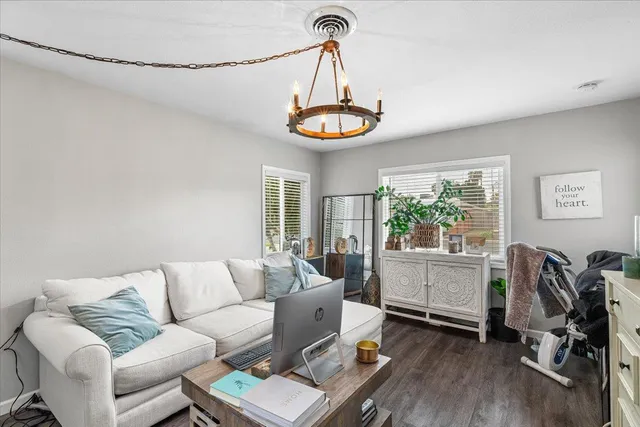 a living room with furniture a window and a chandelier
