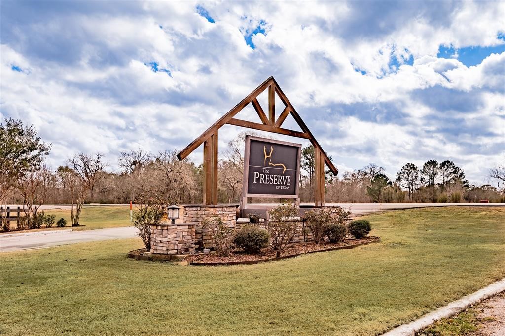 Lot 305 Trinity Drive Cleveland, TX 77327 - Photo 3 of 11 a view of a lake with a house in the background