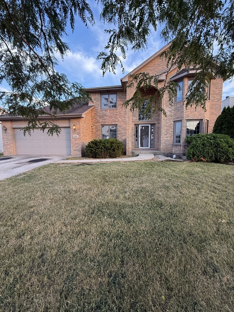 front view of a house with a yard