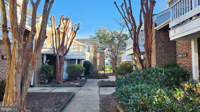 a view of a house with wooden deck front of house