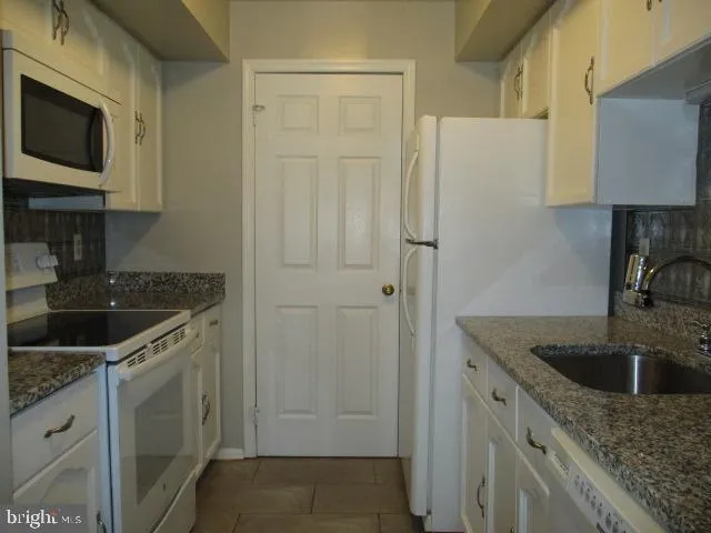 a kitchen with a sink and a refrigerator