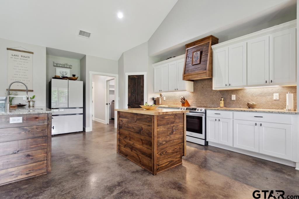 15767 County Road 285 Tyler, TX 75707 - Photo 14 of 44 a kitchen with cabinets oven and refrigerator
