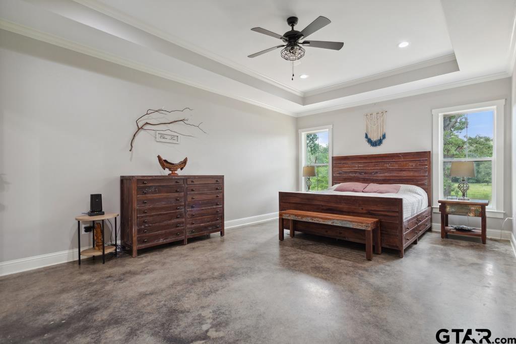 15767 County Road 285 Tyler, TX 75707 - Photo 20 of 44 a bedroom with a bed and ceiling fan