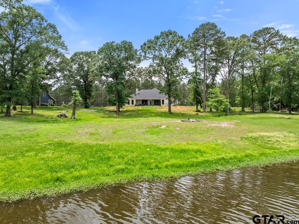 15767 County Road 285 Tyler, TX 75707 - Photo 2 of 44 a big yard with trees in front of it
