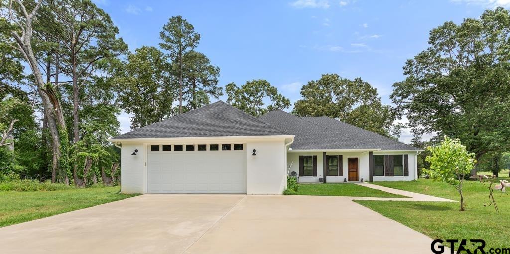 15767 County Road 285 Tyler, TX 75707 - Photo 2 of 44 a front view of a house with a yard and trees