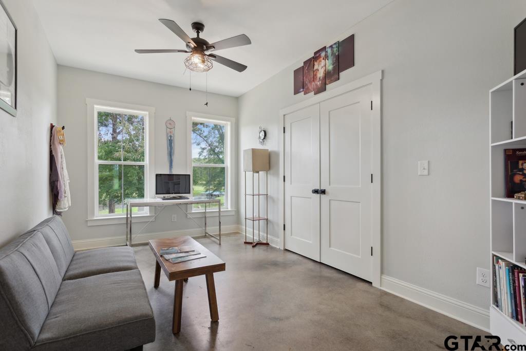 15767 County Road 285 Tyler, TX 75707 - Photo 29 of 44 a living room with furniture a large window and a chandelier