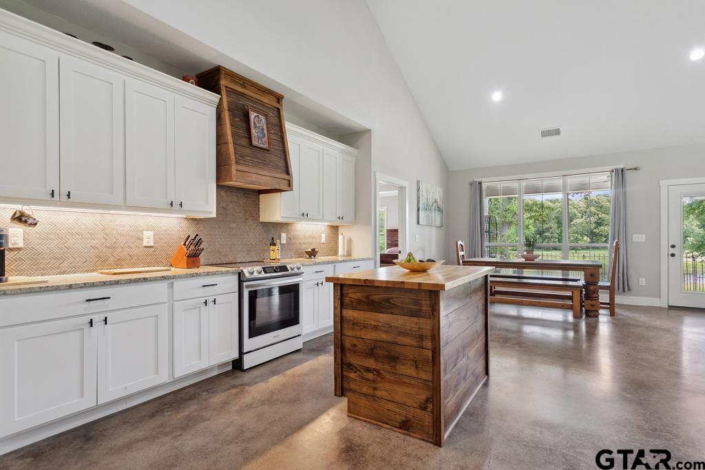 15767 County Road 285 Tyler, TX 75707 - Photo 43 of 44 a kitchen with granite countertop a stove top oven sink and cabinets