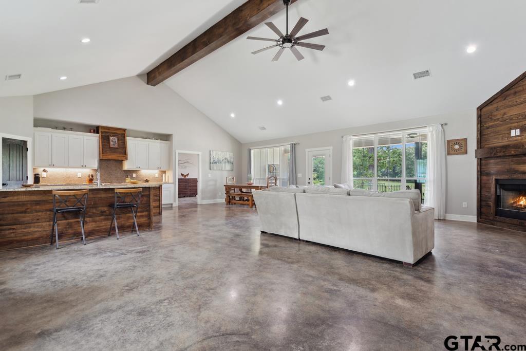 15767 County Road 285 Tyler, TX 75707 - Photo 5 of 44 a living room with furniture a table and kitchen view