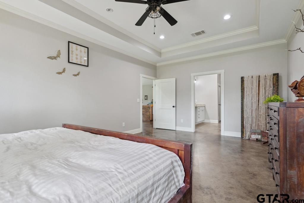 15767 County Road 285 Tyler, TX 75707 - Photo 7 of 44 a bedroom with a bed and a chandelier