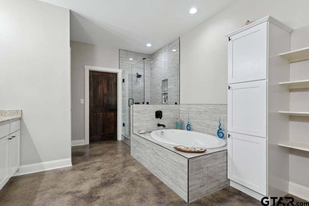 15767 County Road 285 Tyler, TX 75707 - Photo 9 of 44 a bathroom with a tub a sink and a large mirror