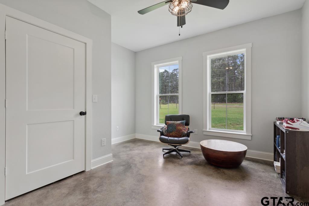 15767 County Road 285 Tyler, TX 75707 - Photo 10 of 44 a living room with furniture a flat screen tv and a window