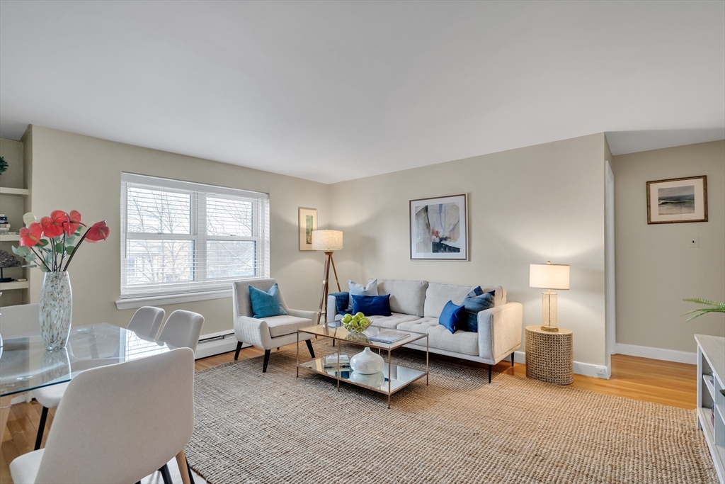 a living room with furniture and flowers