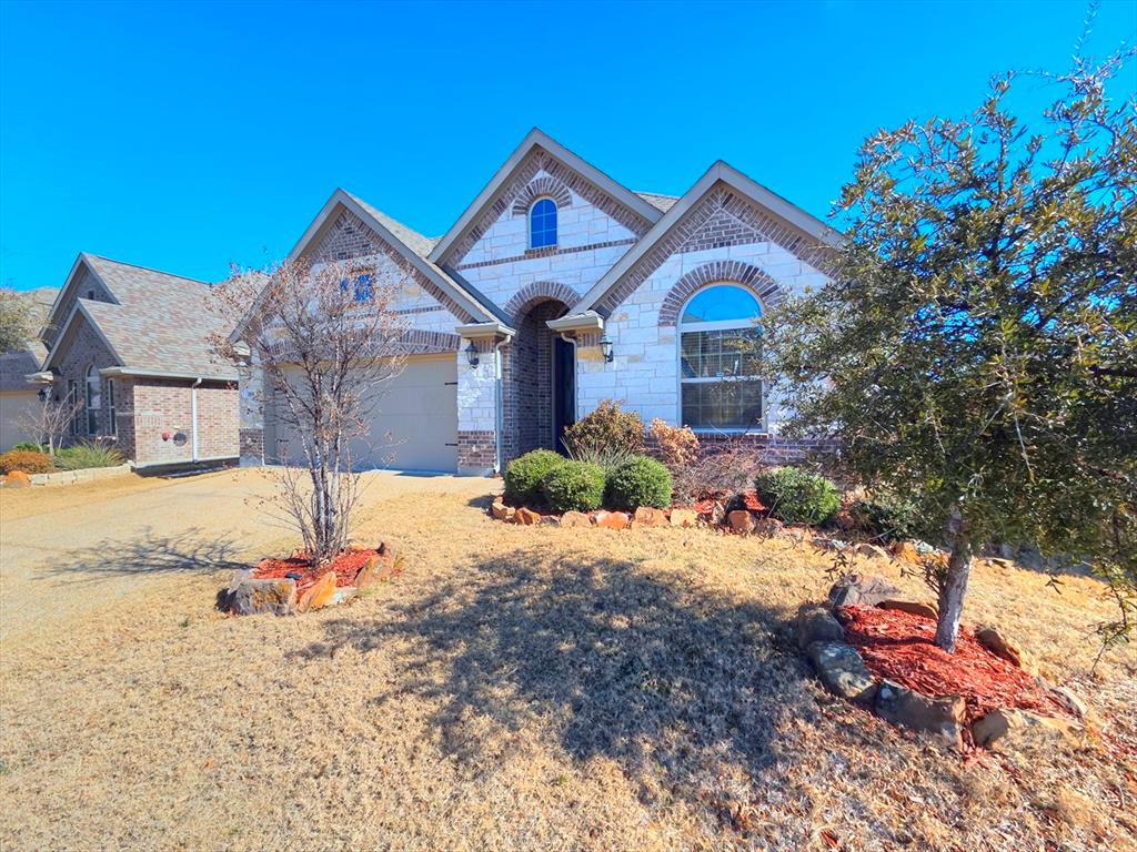 355 Prairie Ridge Lane Lewisville, TX 75056 - Photo 2 of 24 a front view of a house with a yard