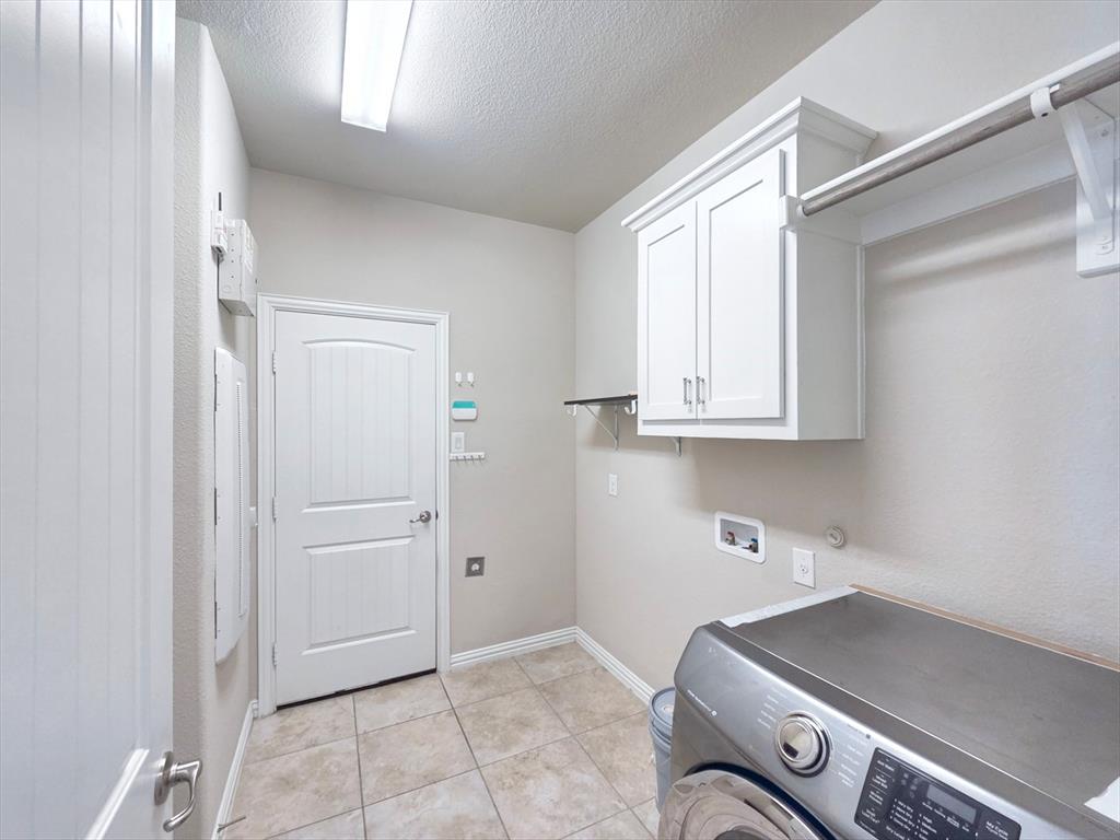 355 Prairie Ridge Lane Lewisville, TX 75056 - Photo 21 of 24 a kitchen with cabinets and window