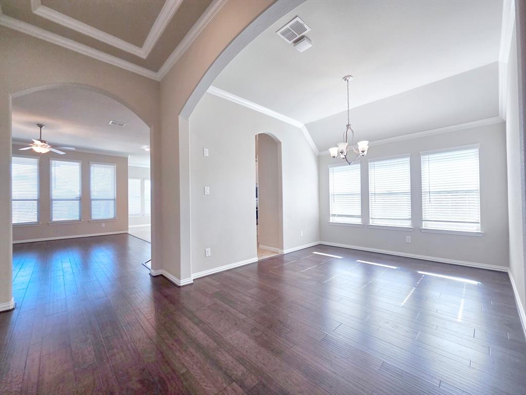 355 Prairie Ridge Lane Lewisville, TX 75056 - Photo 4 of 24 a view of an empty room with wooden floor and a window