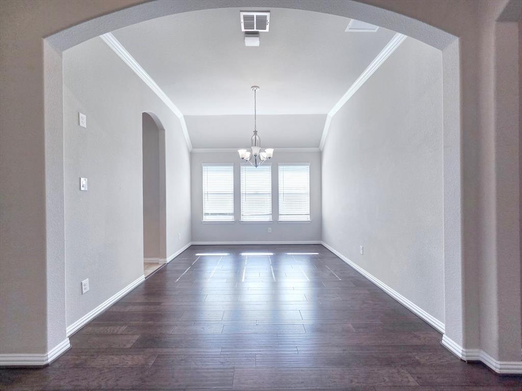 355 Prairie Ridge Lane Lewisville, TX 75056 - Photo 5 of 24 a view of an empty room with wooden floor and a window