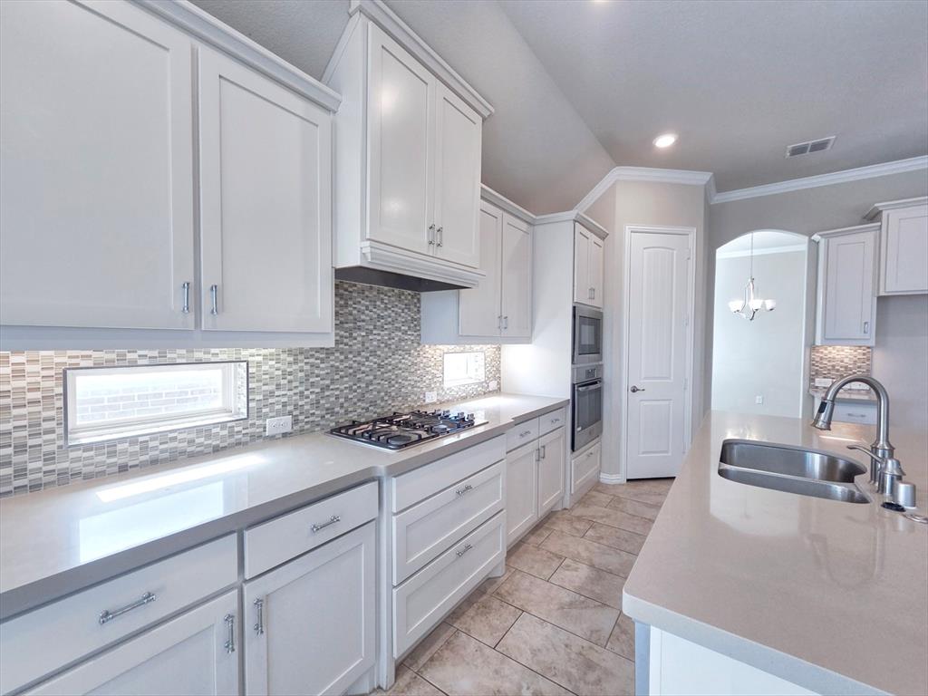 355 Prairie Ridge Lane Lewisville, TX 75056 - Photo 9 of 24 a kitchen with granite countertop a sink stainless steel appliances and cabinets