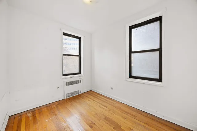 a kitchen with appliances a refrigerator and cabinets