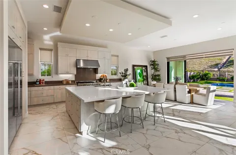 a kitchen with stainless steel appliances granite countertop a stove a sink and a granite counter tops