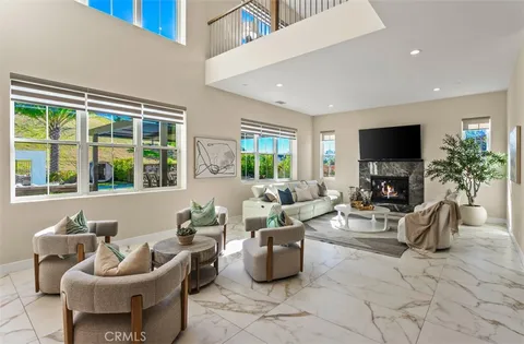 a living room with furniture and floor to ceiling windows