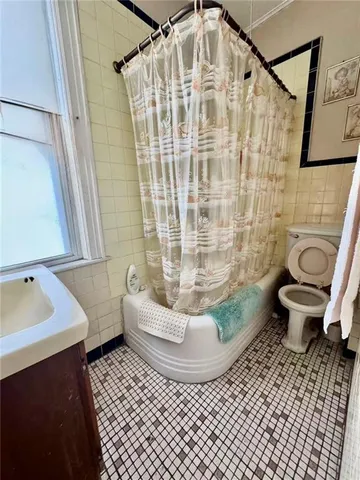 a bathroom with sink toilet and window