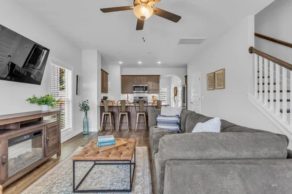 a living room with furniture kitchen view and a fireplace