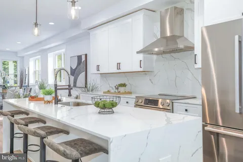 a kitchen with a refrigerator and a sink