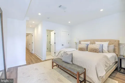 a bedroom with a bed and a mirror