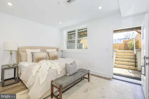 a bathroom with a granite countertop sink a mirror and shower