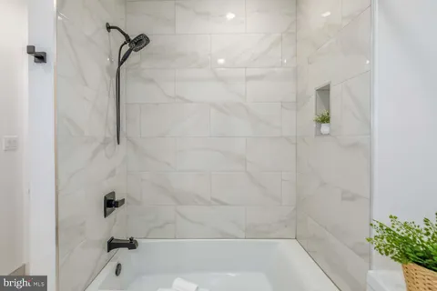 a bathroom with a tub sink and mirror