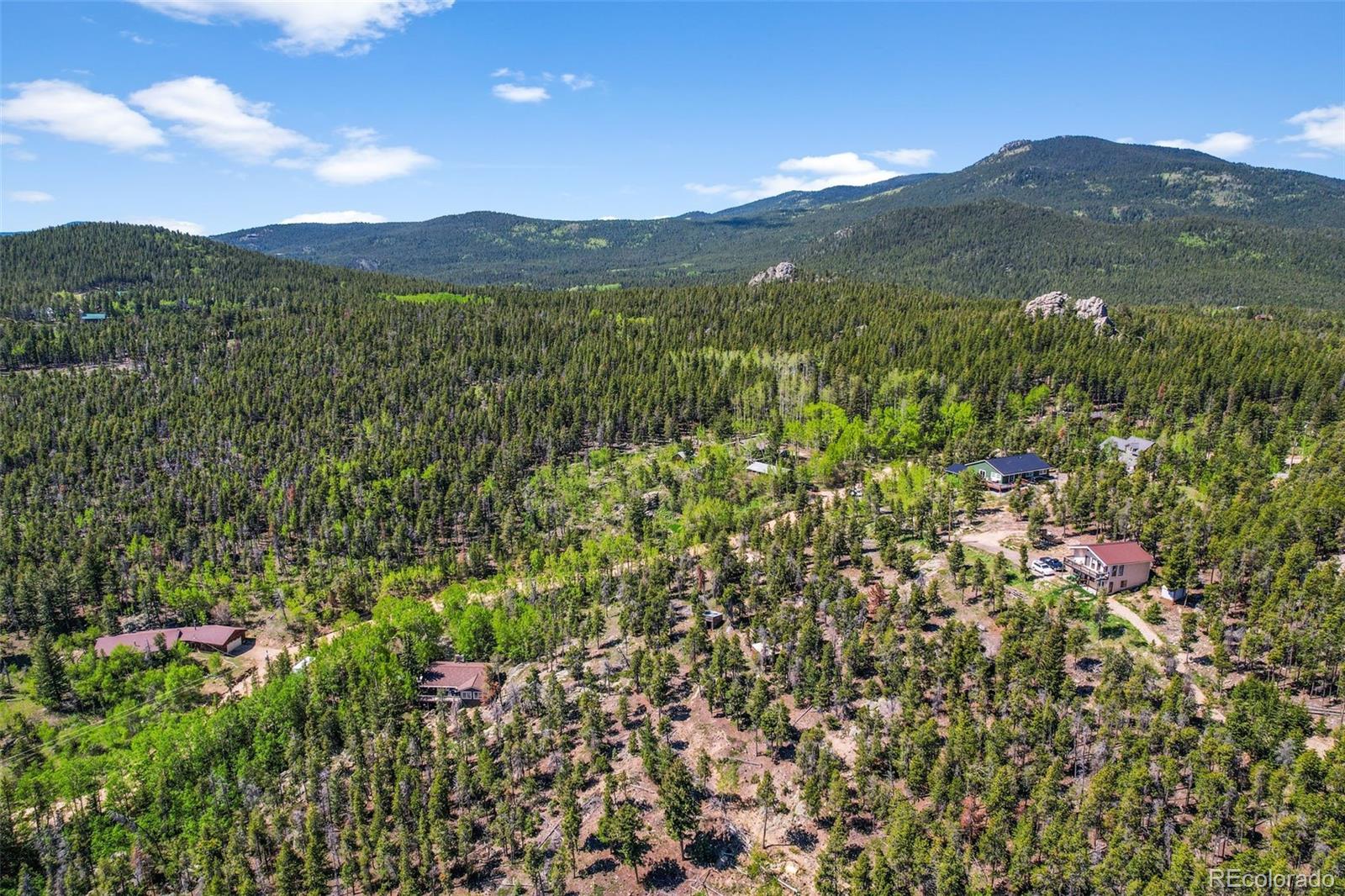 900 Rudi Lane Golden, CO 80403 - Photo 5 of 21 a view of a lush green hillside and a houses