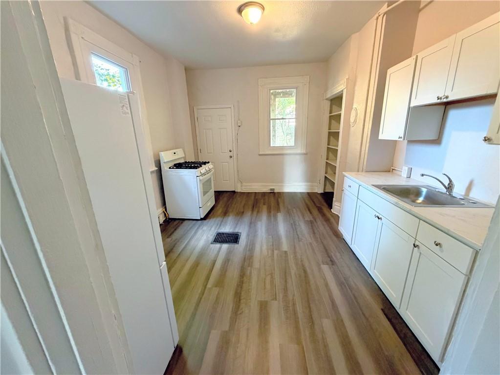 7709 Bennett Street, Unit 1 Pittsburgh, PA 15208 - Photo 5 of 6 a kitchen with a sink and wooden floor