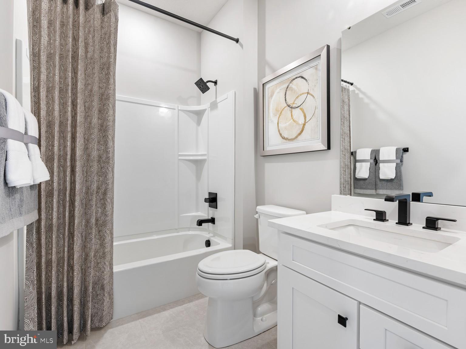 1774 Mill Branch Drive Laurel, MD 20708 - Photo 4 of 5 a bathroom with a toilet sink vanity tub and shower