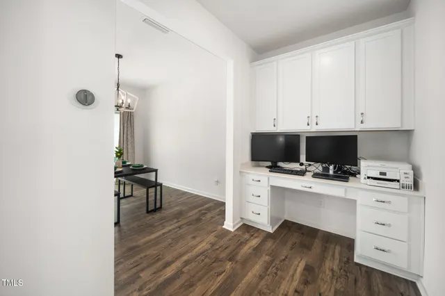 a open kitchen with white cabinets and stainless steel appliances